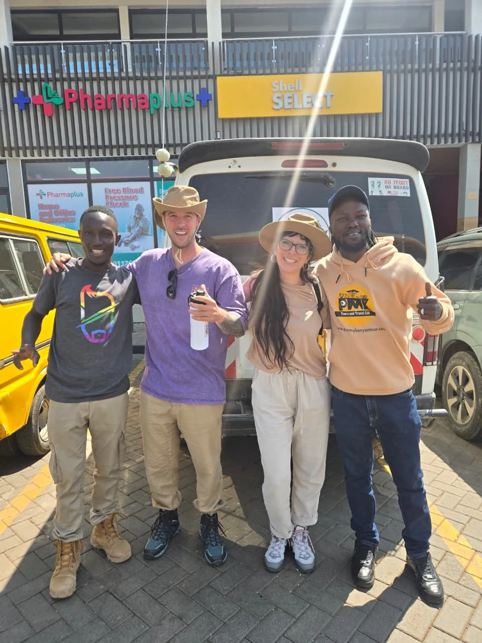 PMK team and safari guests together beside a safari vehicle