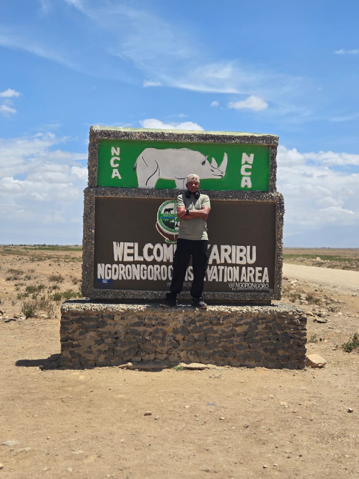 William at the Ngorongoro Conservation Area welcome sign in Tanzania