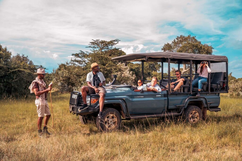 Professional safari guide welcoming guests before a game drive with a genuine Kenya safari company