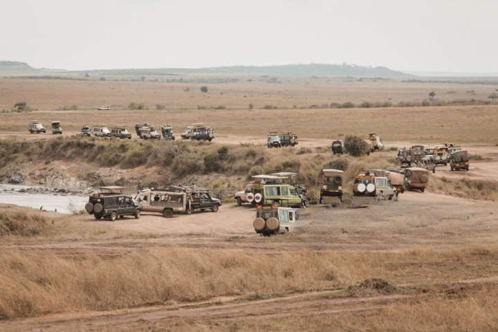 Safari vehicle travelling through Kenya on the road to Masai Mara